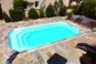 Une coque de piscine rectangulaire à fond plat avec escalier banquette